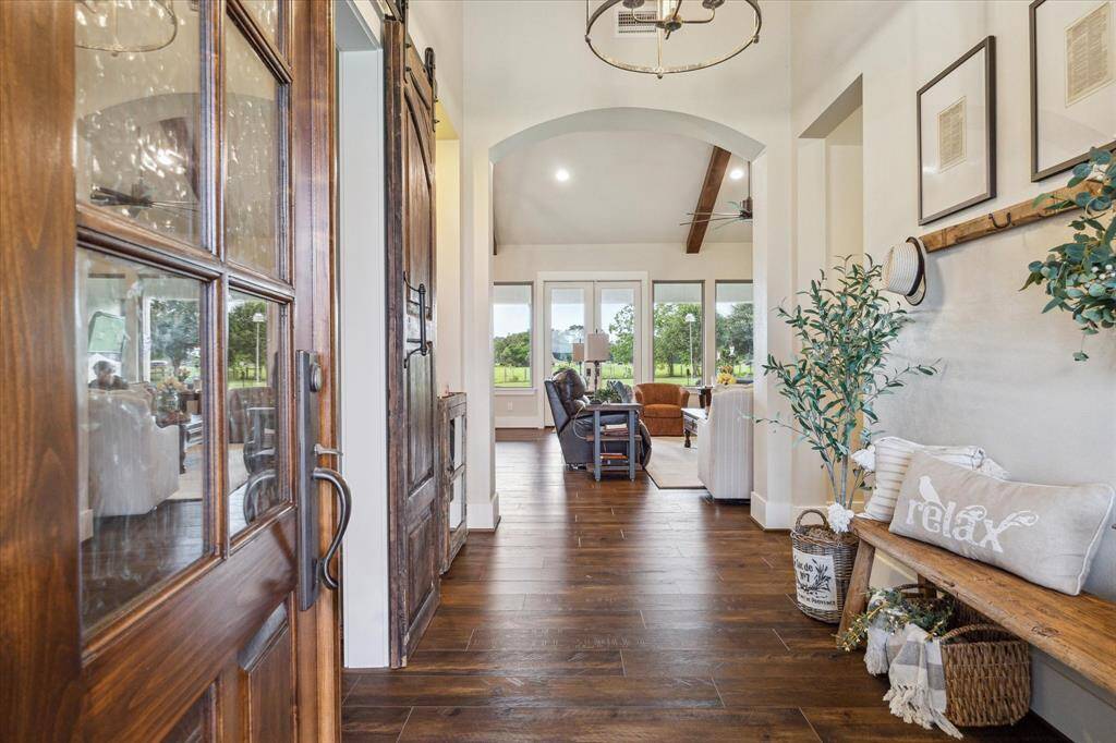 Charming entryway with statement wood accents and sightlines to the living room and beyond.