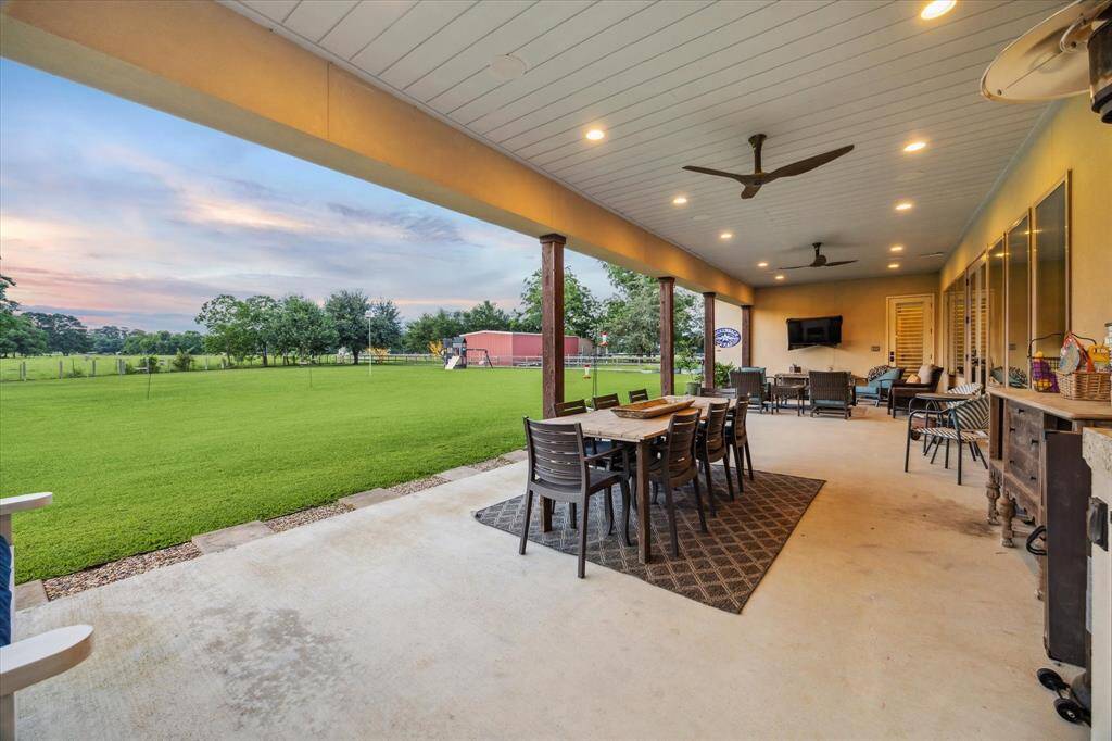 Room to dine, unwind, and host with a view - this oversized patio opens to peaceful acreage in every direction.