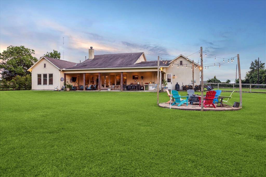 Gather 'round - this backyard features a charming fire pit with café lights, ready for laughter, stories, and s’mores.