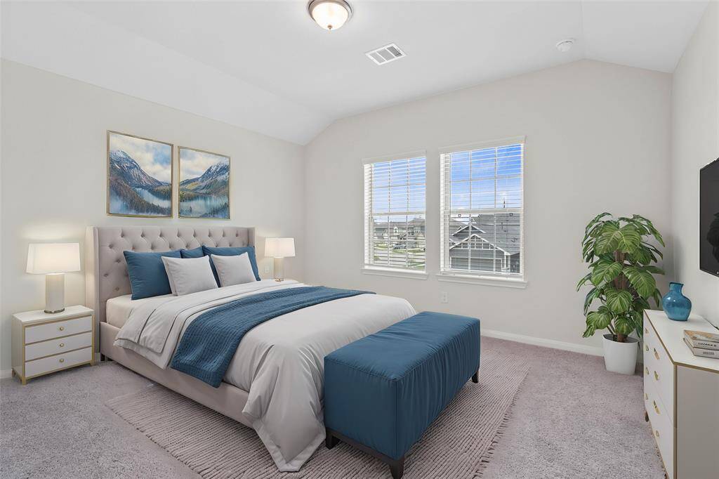 Secondary bedroom features plush carpet, neutral paint, raised ceilings, closet space, and large windows with blinds. *virtually staged*
