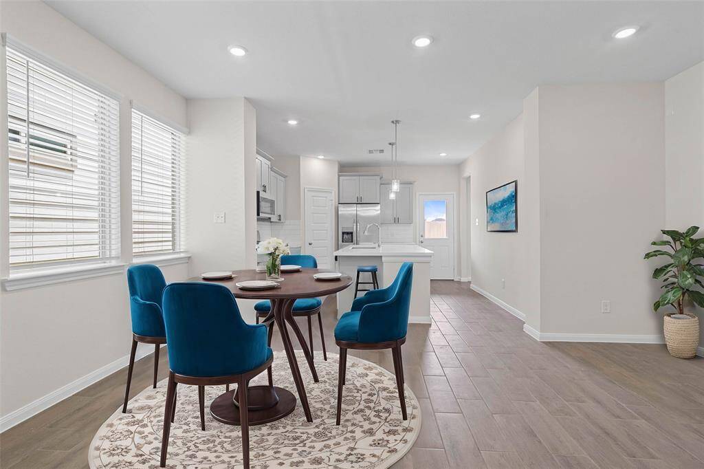 This lovely breakfast area is perfect for starting the day out on the right foot!  This space showcases custom paint, high ceilings, recessed lighting, large windows adding to the ample natural light and tile flooring! *virtually staged*