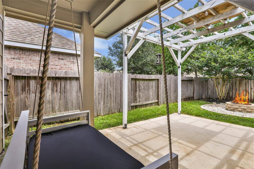 Covered Patio with full size swing and fire pit