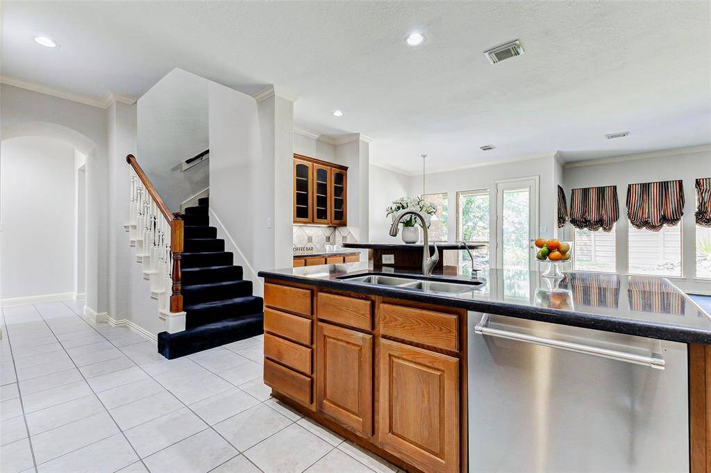 Another view of the kitchen area and the secondary staircase leading to the 2nd floor, adding to the home's charm and functionality.