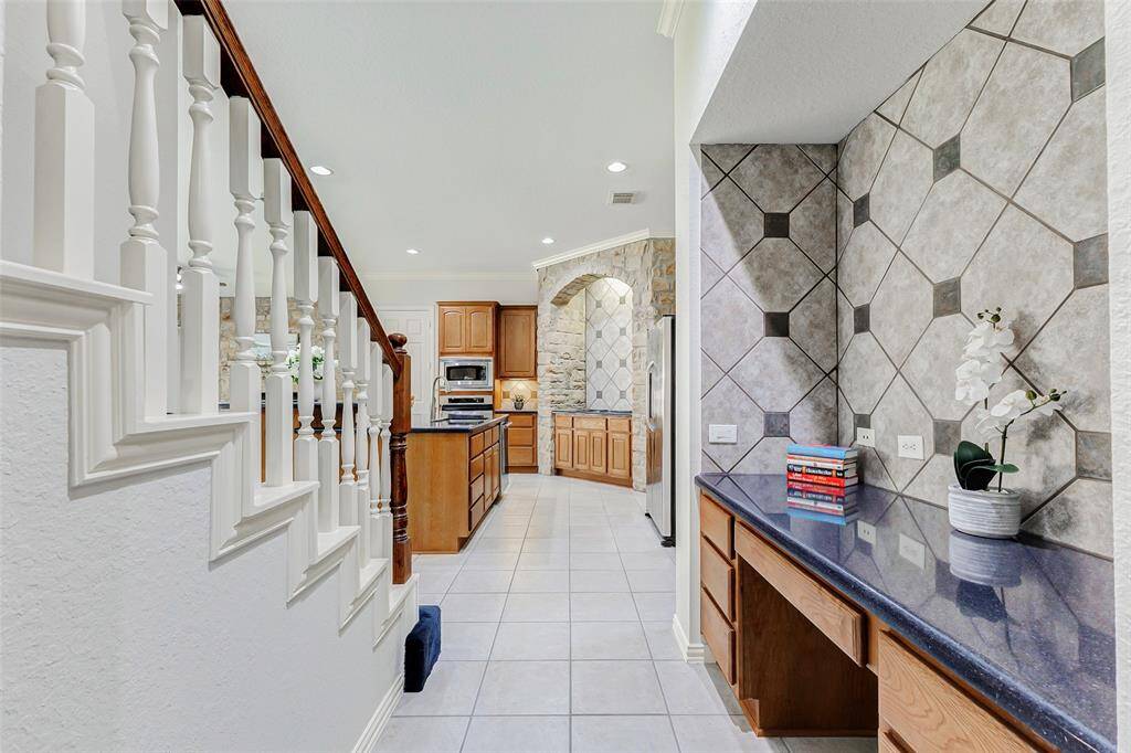 There's a built-in desk area adjacent to the kitchen & staircase adding convenience and functionality to this charming home.