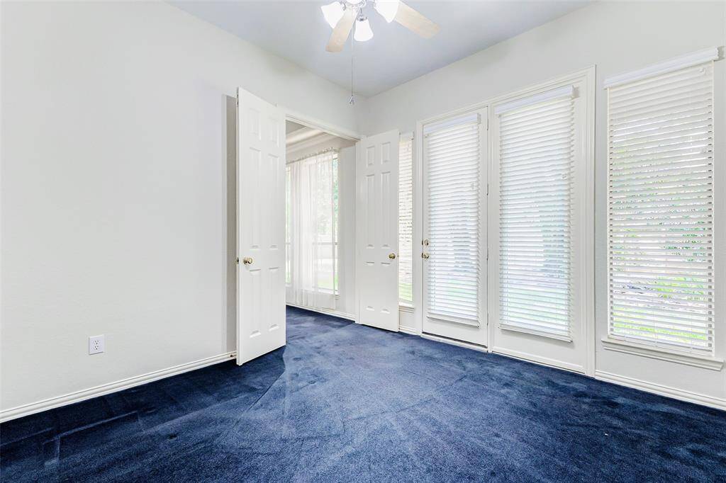The extra room off the primary bedroom is perfect for a nursery, office or workout room. This room features large windows with blinds and door leading out to the back covered porch. Double doors lead back to the primary bedroom and can be closed for privacy.