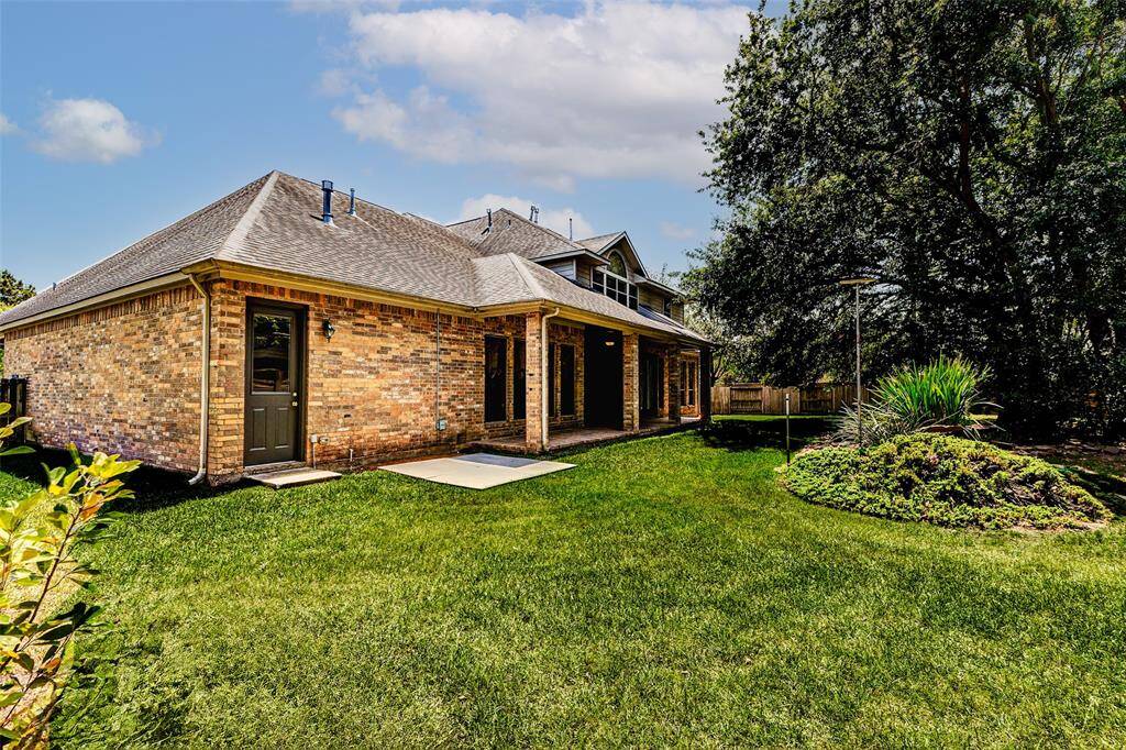 This spacious backyard with mature trees, offers a private and serene outdoor space. The covered patio is perfect for entertaining family & friends.