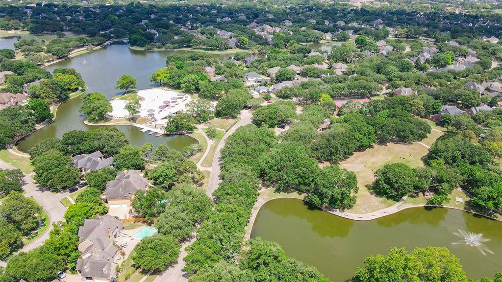 An aerial photo of the Beach Club, surrounding lakes, playground within the Cinco Ranch neighborhood.