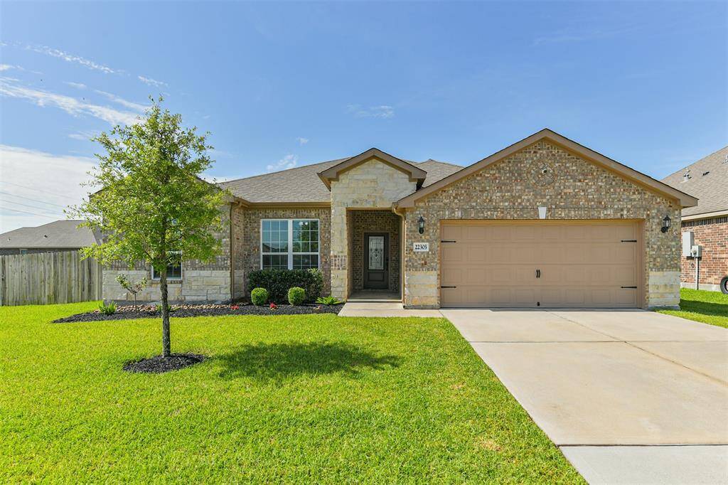 Welcome home to 22303 Bauer Garden Dr with its beautiful brick and stone elevation and landscaped beds.