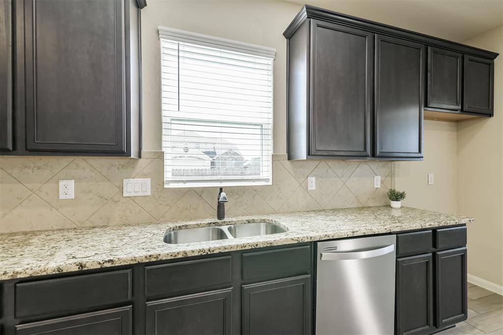 Kitchen window looks to the ample side yard with no close neighbors.