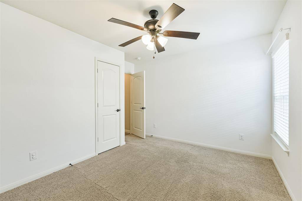 Second bedroom with large closet and ceiling fan.