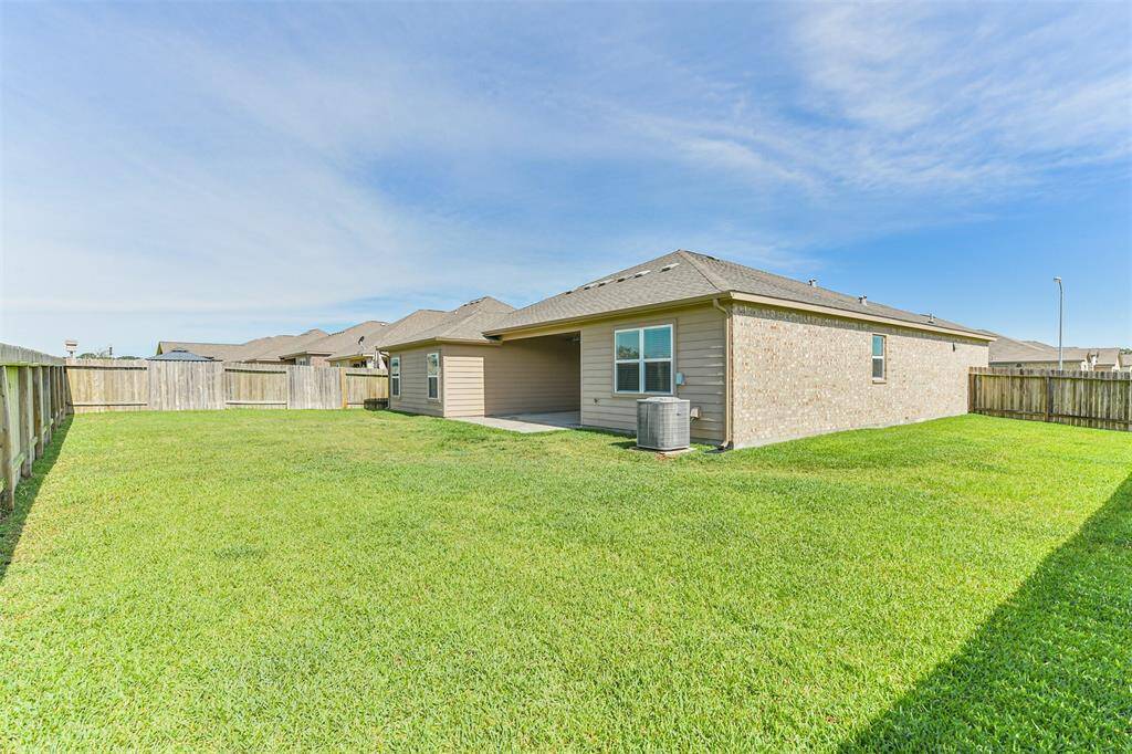 Huge yard surrounds this house with full gutters and sprinkler system.