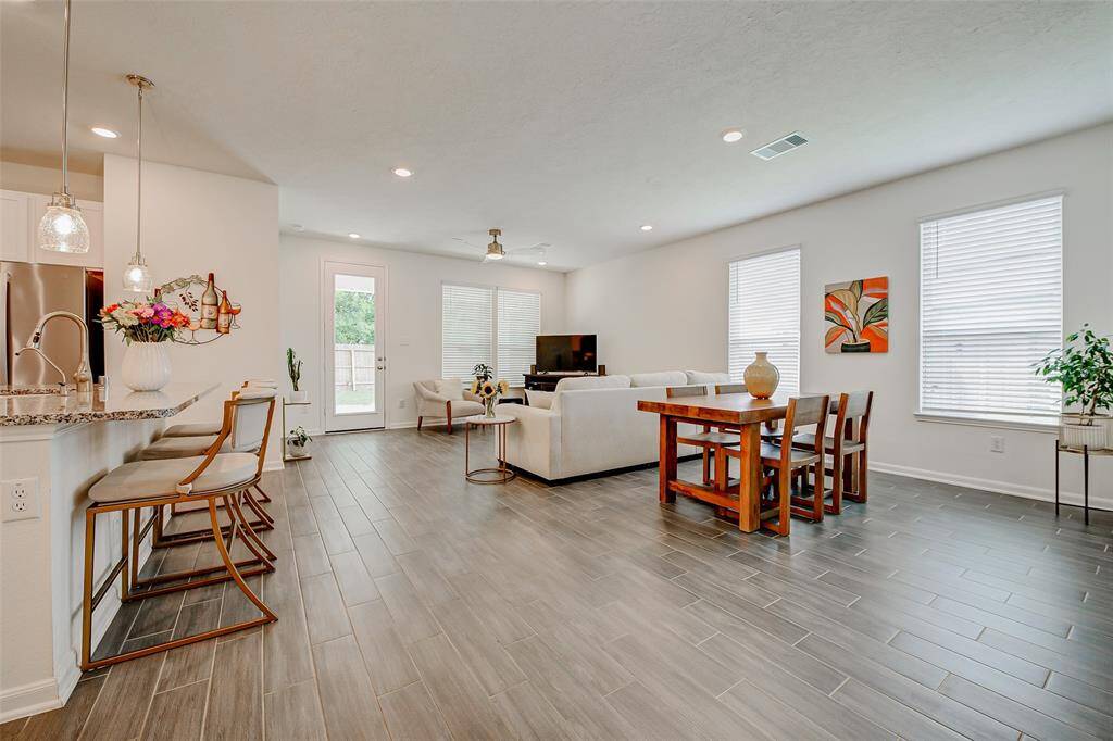 This open-concept floor plan seamlessly connects the kitchen, dining, and living areas—ideal for entertaining and everyday living.
