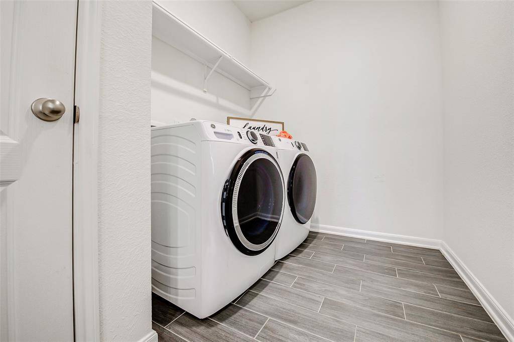 This utility space is located off of the kitchen and has great extra storage.