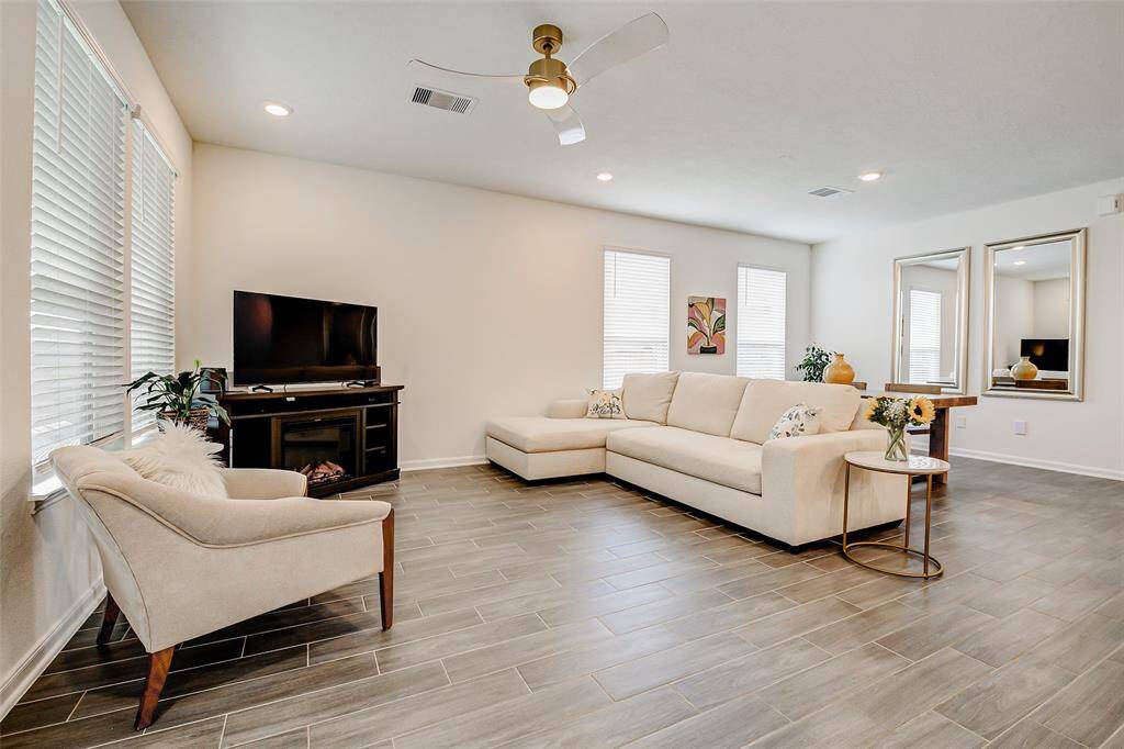 Lots of windows flood the room with natural light, and the seamless flow into the open living and dining areas makes this the ultimate gathering space.
