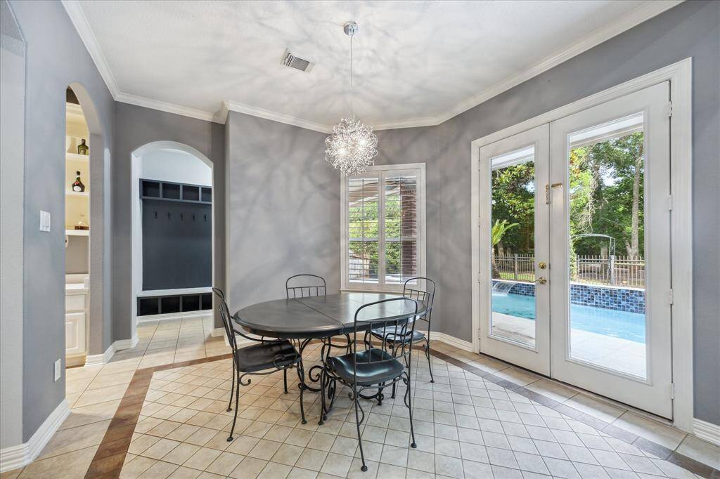 Mudroom-Connected Breakfast Nook: Just off the kitchen, this bright dining space connects seamlessly to the updated MUD room, dry bar, half bath, storage closet, garage entry, and door to the backyard and pool making this space a central hub for everyday flow
