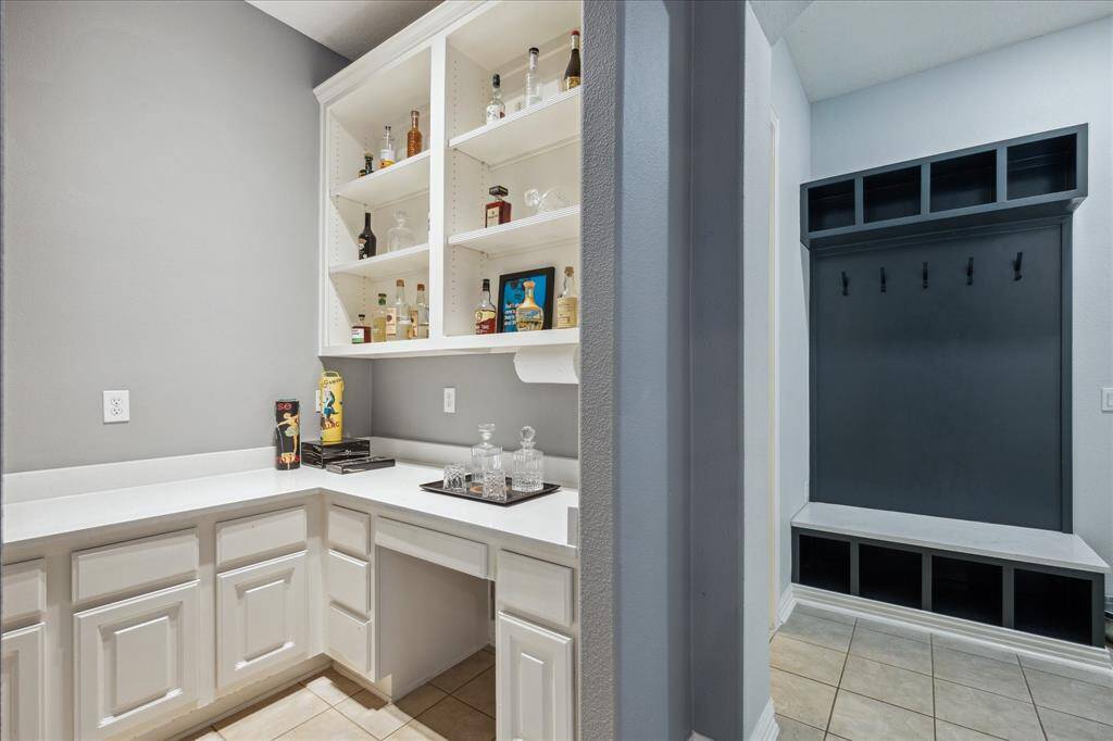 Versatile Dry Bar: Built-in shelving, lower cabinetry, and carrara marble counters make this updated space ideal as a wine room, dry bar, scullery kitchen, or even a tucked-away downstairs office nook.