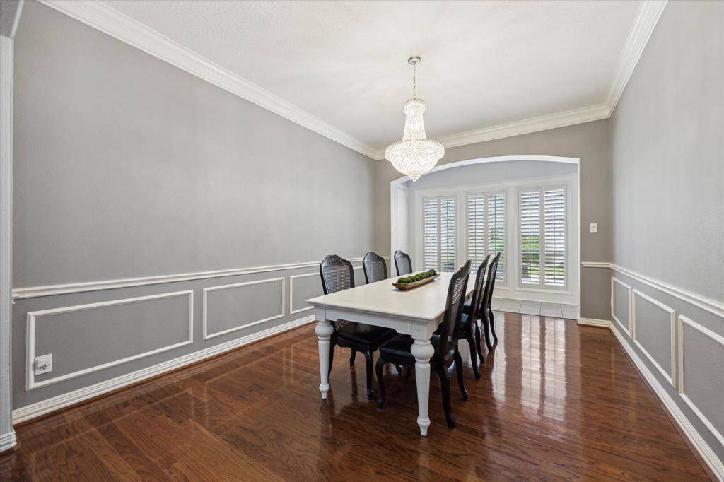 Elegant Dining with Timeless Charm: Crown molding, rich wood floors, and floor-to-ceiling windows create a space made for holidays, celebrations, and everyday gatherings.
