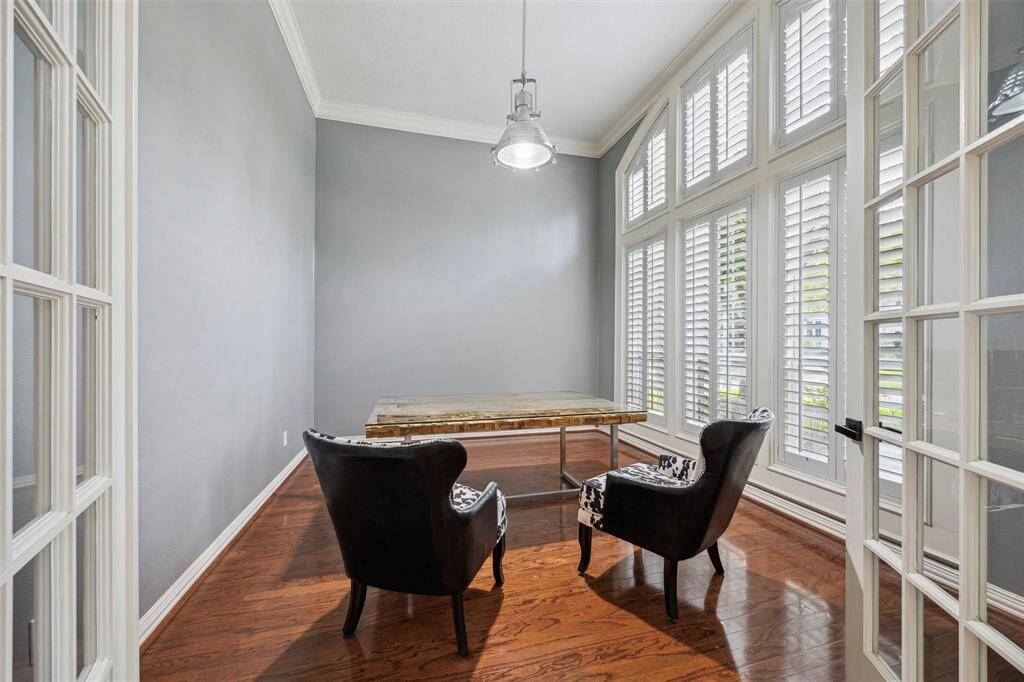 Private Study with Floor-to-Ceiling Windows: Set behind French doors, this bright workspace is framed by soaring 15’ ceilings and sunlight from a full wall of windows.