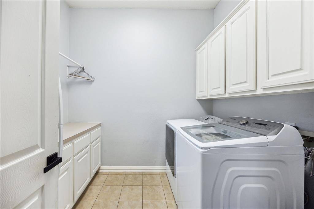 Laundry Room with Room to Spare: Built-in cabinets, folding space, and even room for a fridge make this oversized laundry room as hardworking as it is spacious.