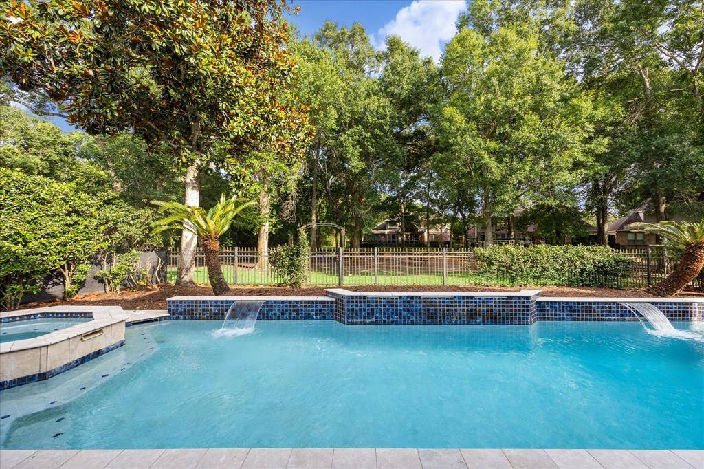 Peaceful Poolside Views Framed by Nature: With no rear neighbors and mature trees lining the preserve, this poolside perspective offers the perfect blend of privacy and serenity.