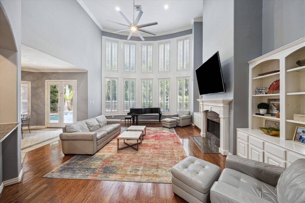 Light-Filled Living Room with Nature Views: A dramatic wall of windows frames views of the pool and wooded reserve just beyond your backyard, filling the space with natural light from morning to dusk.