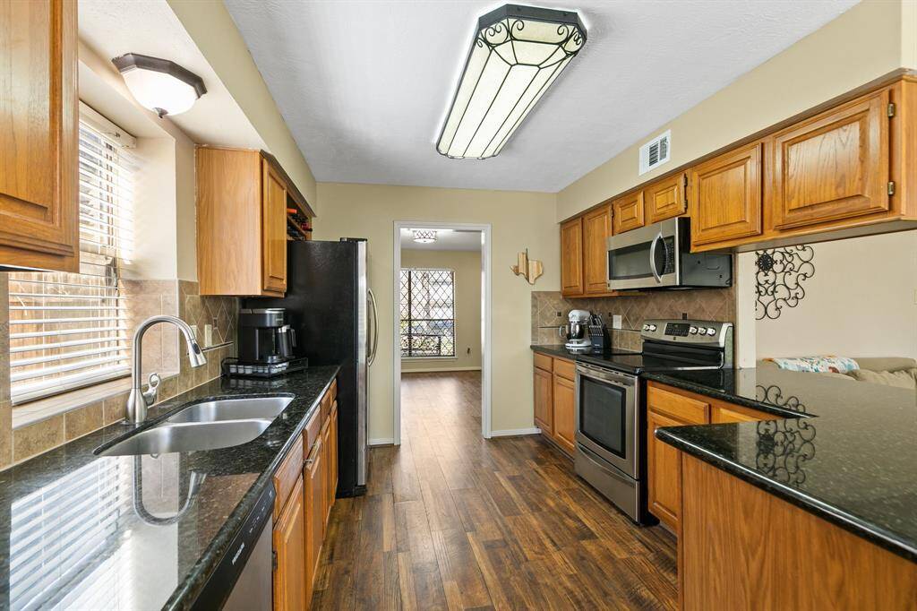 From this view of the kitchen, you can see the connection to the dining room, creating an open and inviting flow between the two spaces.