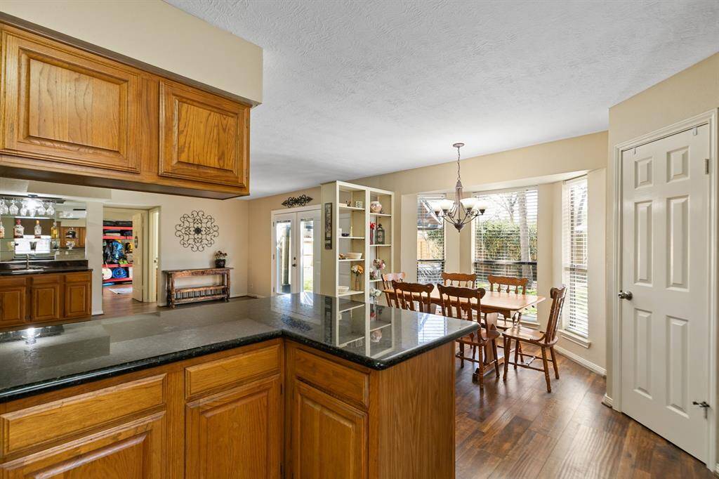 No raised bar - the kitchen offers a flat countertop with space for barstools on the other side, perfect for casual seating.