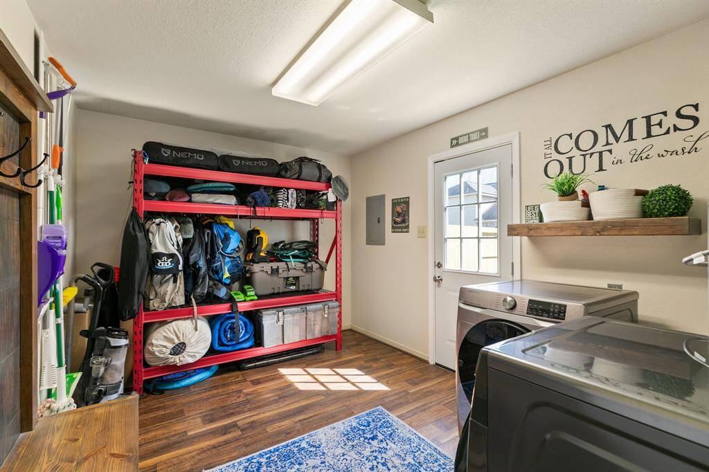 This huge laundry room provides plenty of space for storage making it perfect for organizing some of your household items. The gas water heater is conveniently located here-not in the attic! There are two doors - one leading to the backyard and one to the garage