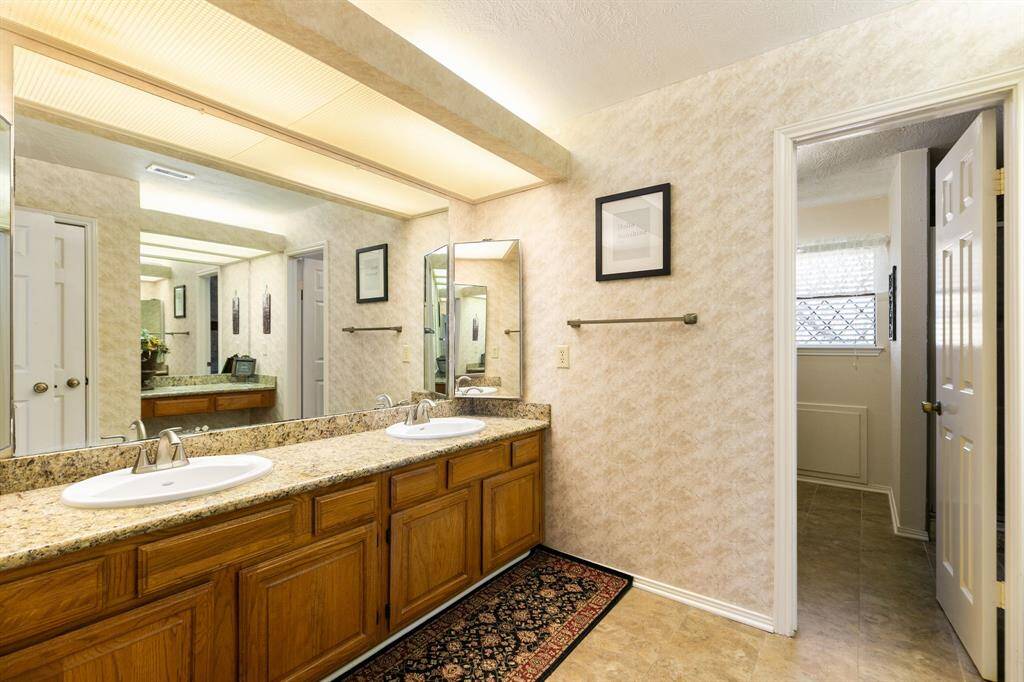 The bathroom features updated granite countertops and two separate sinks, allowing two people to use the space simultaneously without feeling crowded. There is a separate linen closet for your towels and bed linens keeping them organized