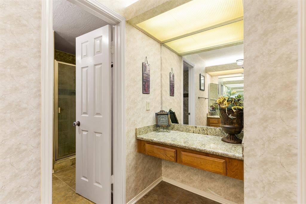 There is a separate vanity area where you can sit while applying makeup or fixing your hair. It is a great spot for storing makeup, jewelry, or other personal items