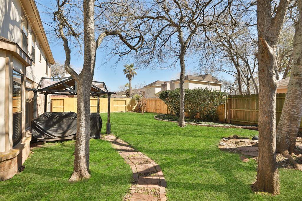 Surrounded by a new fence on two sides and shaded by towering hardwood trees, there is plenty of space for pets to roam or children to play.
