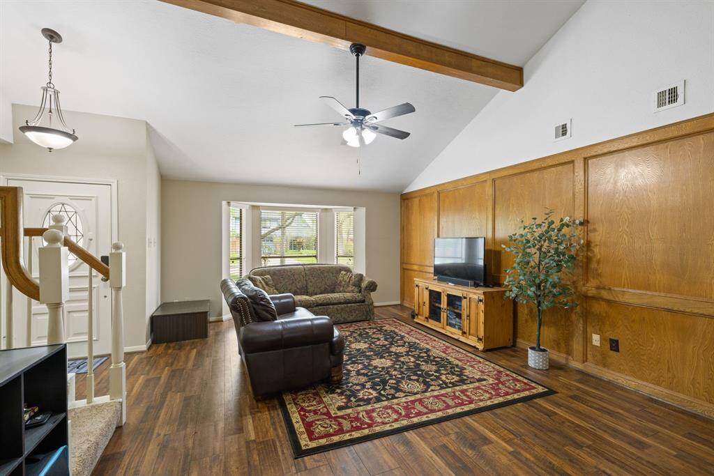 To the left of the front door is the living room. A full brick fireplace extends from the floor to the ceiling, reaching all the way up to the 2nd story. This fireplace becomes a focal point that anchors the room