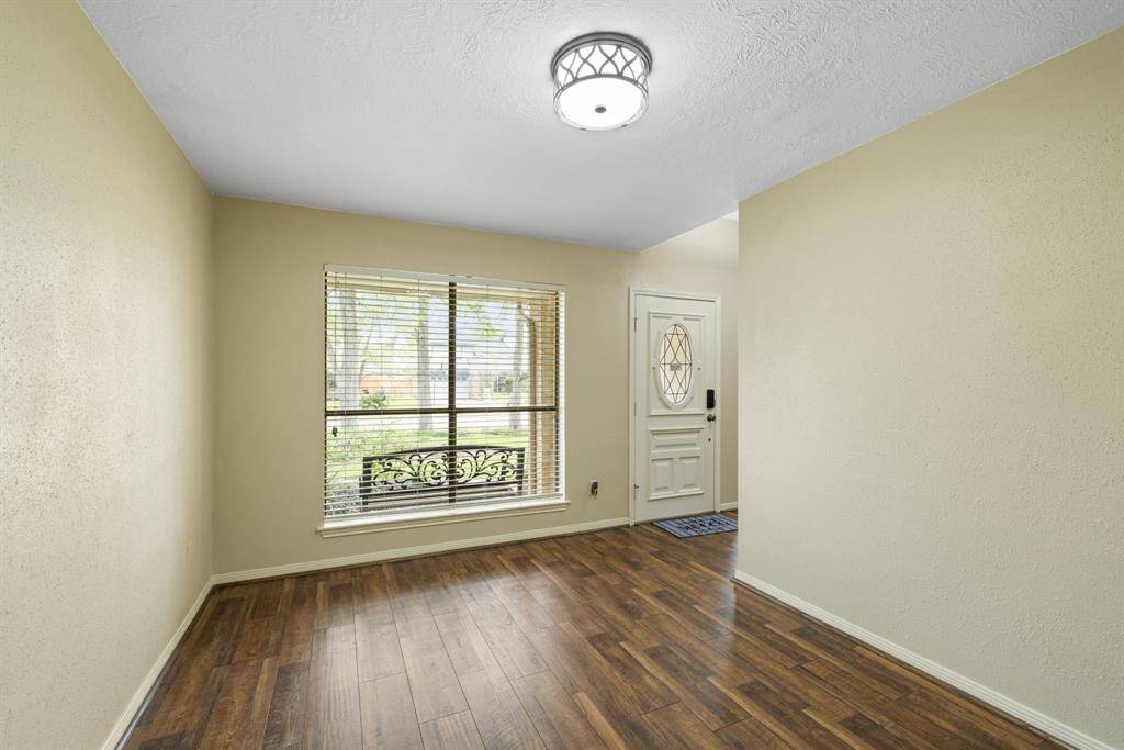 The family room offers versatile space, ideal for a game room with a pool table or a playroom for the kids. French doors open to the backyard, providing easy access to outdoor living, while a wet bar enhances the space for hosting guests and enjoying refreshments.