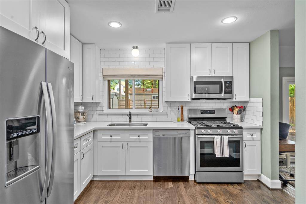 The kitchen is equipped with sleek stainless steel appliances.