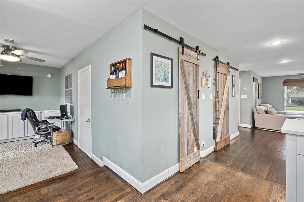 The barn doors lead to the utility room and storage.