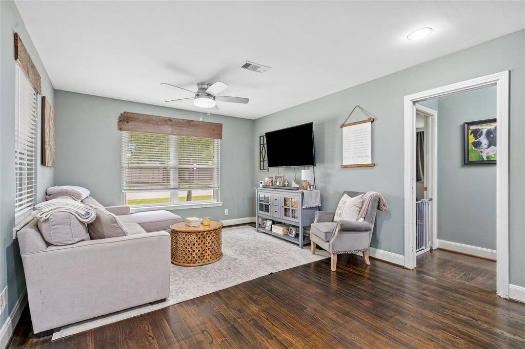 Bright living area with beautiful wood flooring.