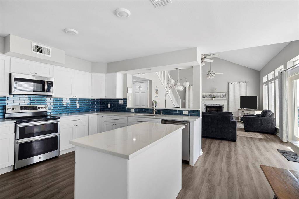 Open-concept design seamlessly connects the modern kitchen to the spacious living area, creating an ideal layout for entertaining and everyday comfort.