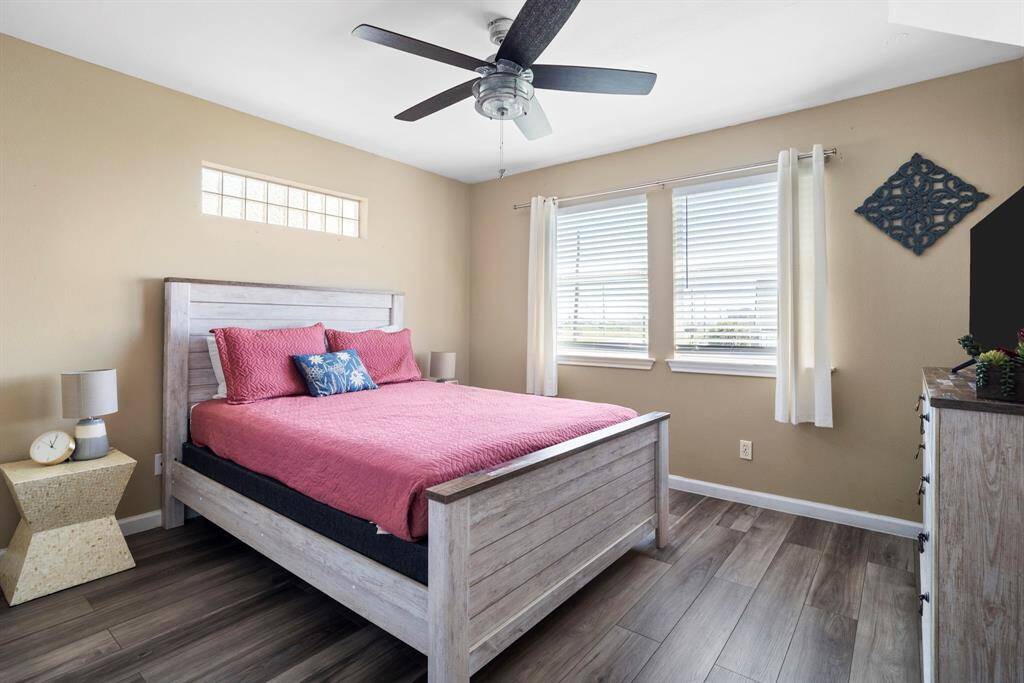 Inviting secondary bedroom with abundant natural light, updated flooring, and clean, coastal finishes—perfect for guests or family.