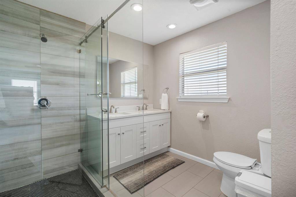 Freshly updated bathroom with sleek glass shower, modern vanity, and warm neutral tones for a clean, contemporary feel.