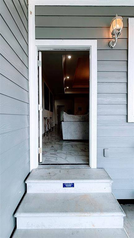 Welcoming entryway with light gray siding.