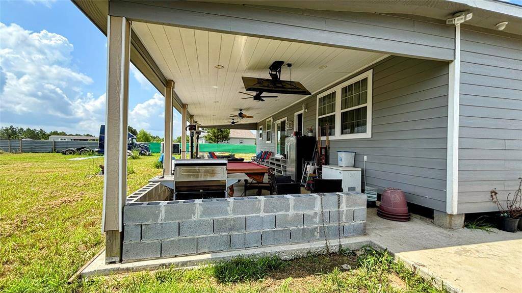 Spacious covered back patio, perfect for outdoor relaxation.