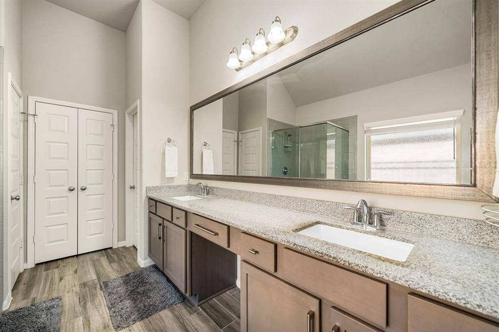 This primary bathroom is definitely move-in ready! Featuring a walk-in shower with tile surround, separate garden tub for soaking after a long day with custom tile detailing, Granite countertops, spacious walk-in closet, high ceilings, neutral paint, sleek and modern finishes.