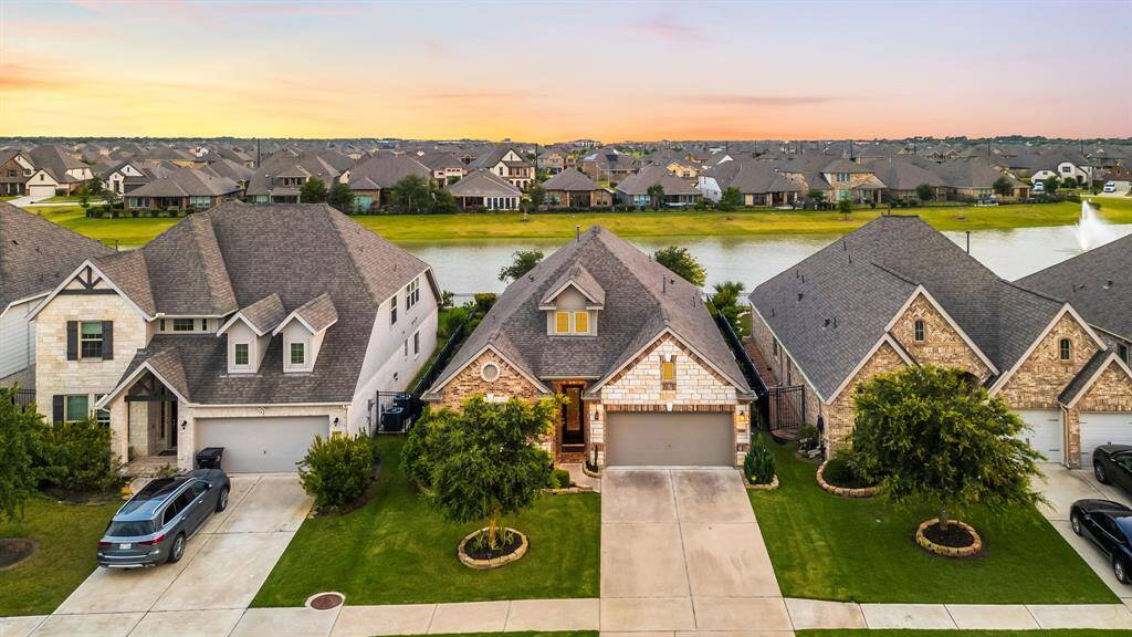 Amazing aerial shot of this gorgeous home situated on a lake lot on a quiet street in the sought after Lakes of Bella Terra West zoned to Lamar Consolidated ISD. Lush landscaping, well manicured front lawn and a wonderful back patio perfect to set up, an outdoor sitting area and a beautiful view of the lake with no back neighbors.