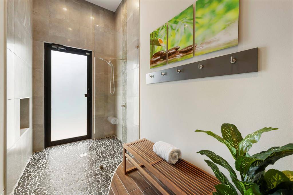 The pool bath features a spa-like walk-in shower with direct outdoor access.