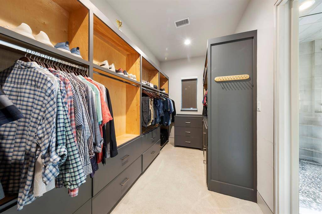 This custom walk-in closet offers sleek built-ins, abundant drawer space, and smart organization for both everyday essentials and statement pieces.