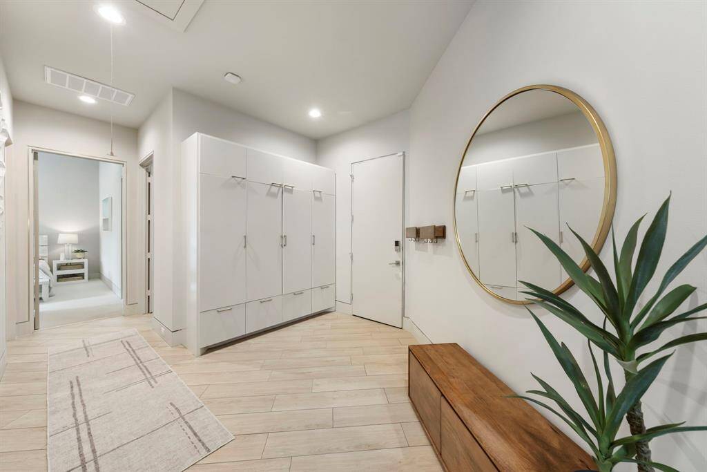 This welcoming mudroom combines functionality with modern design, featuring floor-to-ceiling storage for effortless organization and style.