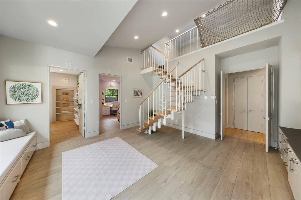 Charming playroom with an upper loft connects two secondary bedrooms—perfect for kids or teens to play, study, or relax.