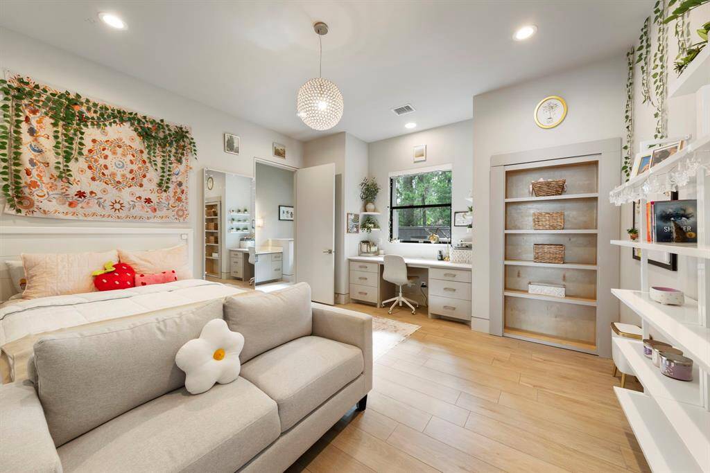 Almost identical secondary bedroom with a built-in desk and private en-suite bath. The hidden bookshelf reveals a walk-through closet that connects to the adjoining bedroom.