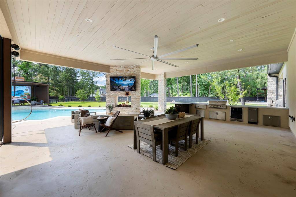 This covered outdoor living space is an entertainer’s dream—designed for effortless gatherings and year-round enjoyment. Featuring a full outdoor kitchen, built-in grill, beverage fridge, and fireplace, it offers seamless indoor-outdoor living with resort-style comfort and functionality.