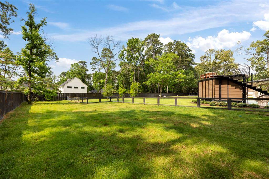 Fully fenced and lush with mature trees, this private green space is ideal for pets, play, or future garden beds.